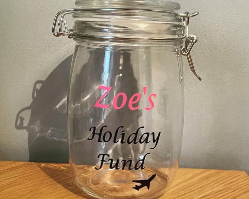 A budget-friendly glass jar dedicated to holiday funds